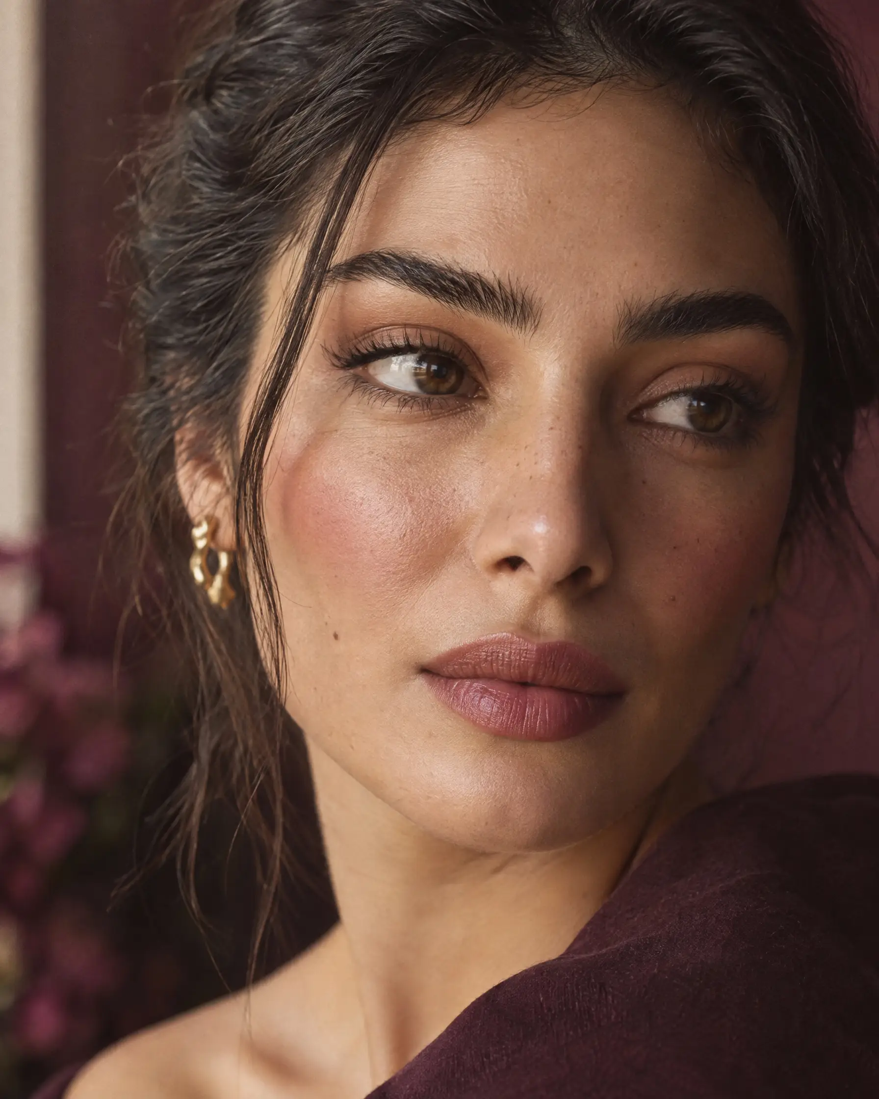 Close-up of a woman with full, softly groomed natural brows